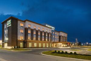 a large building with a sign on top of it at Four Points by Sheraton Kansas City Olathe in Olathe