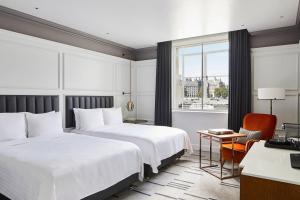 a hotel room with two beds and a window at London Marriott Hotel County Hall in London