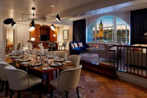 a dining room with a long table and chairs at London Marriott Hotel County Hall in London