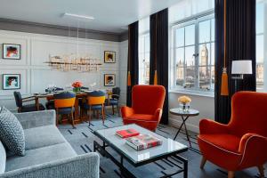 a living room with a couch and chairs and a table at London Marriott Hotel County Hall in London