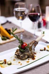 a plate of food on a table with wine glasses at Prive Hotel Bodrum - Adult Only in Bodrum City