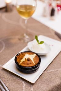 a dessert on a plate with a glass of wine at Prive Hotel Bodrum - Adult Only in Bodrum City