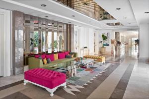 a living room with a couch and a table at Prive Hotel Bodrum - Adult Only in Bodrum City
