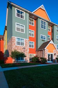 a large apartment building with an orange and green at Residence Inn Columbia in Columbia