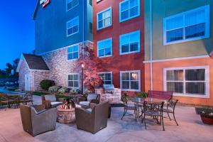 a patio with chairs and tables in front of a building at Residence Inn Columbia in Columbia