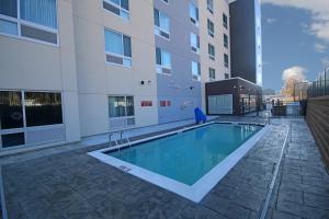 a swimming pool in front of a building at TownePlace Suites by Marriott Greensboro Coliseum Area in Greensboro