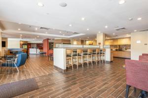 a lobby with a bar and some chairs at TownePlace Suites by Marriott Greensboro Coliseum Area in Greensboro