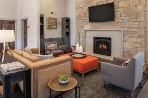 a living room with a fireplace and a tv at Residence Inn Bozeman in Bozeman