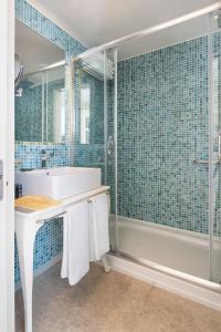 a bathroom with a tub and a sink and a shower at Prive Hotel Bodrum - Adult Only in Bodrum City