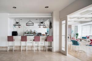 a kitchen and living room with a bar with stools at Prive Hotel Bodrum - Adult Only in Bodrum City