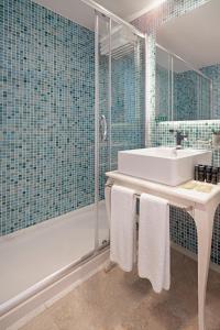 a bathroom with a tub and a sink and a shower at Prive Hotel Bodrum - Adult Only in Bodrum City