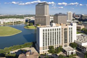 an aerial view of a city with a river and buildings at Marriott Dallas Las Colinas in Irving
