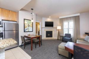 a living room with a kitchen and a dining room at Residence Inn by Marriott Midland in Midland