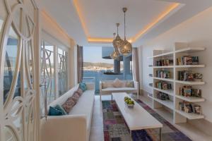 a living room with a couch and a table at Prive Hotel Bodrum - Adult Only in Bodrum City