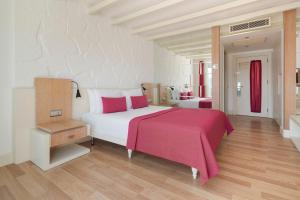 a bedroom with a large bed with a red blanket at Prive Hotel Bodrum - Adult Only in Bodrum City