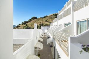 a white house with white walls and white benches at Prive Hotel Bodrum - Adult Only in Bodrum City