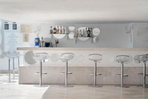 a row of bar stools in front of a counter at Prive Hotel Bodrum - Adult Only in Bodrum City
