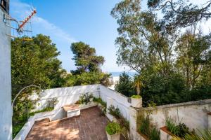 an outdoor patio with stairs and trees at Bilocale - Rosa seaview in villa in Santa Cesarea Terme