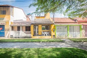 a yellow house with a gate and a yard at Casa de Praia em Morro de São Paulo (Gamboa) in Morro de São Paulo