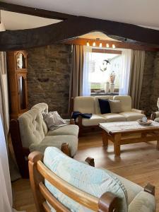 a living room with couches and a table at Ferienhaus Janne in Monschau