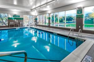 a large swimming pool with blue water in a building at TownePlace Suites by Marriott Leavenworth in Leavenworth
