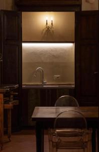 a kitchen with a sink and a table and chairs at Renaissance Palace Noble Floor Apartment in Florence