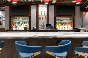 a bar with blue chairs in front of a counter at Residence Inn Franklin Berry Farms in Franklin