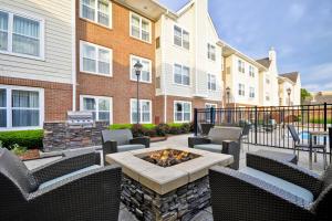 a patio with chairs and a fire pit in front of a building at Residence Inn Lexington South Hamburg Place in Lexington