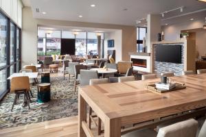 a restaurant with tables and chairs and a flat screen tv at Residence Inn Walnut Creek in Walnut Creek