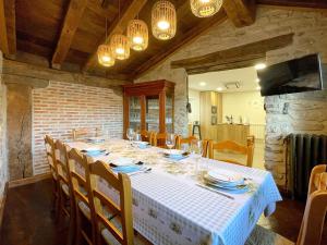 a dining room with a white table and chairs at CASA RURAL ERVITENA in Oteiza