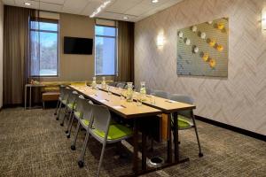 a conference room with a long table and chairs at SpringHill Suites Charlotte at Carowinds in Charlotte