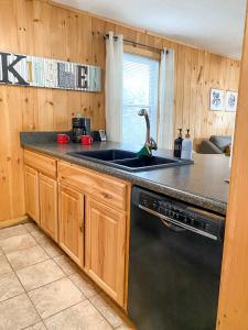 a kitchen with a sink and a stove at Beech Please Cozy Beech Mountain Stay in Beech Mountain +14 photos
