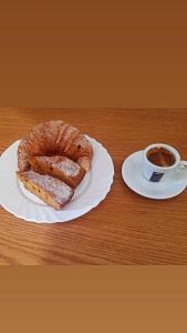 a plate with a pastry and a cup of coffee at Hotel Four Islands in Ksamil