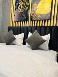 a bedroom with a bed with pillows on it at Yas 2 Apartment in Samarkand