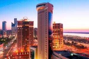 a tall building in a city at night at Le Royal Meridien Abu Dhabi in Abu Dhabi