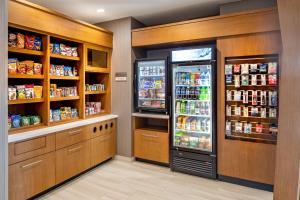a kitchen with two refrigerators and a refrigerator at SpringHill Suites by Marriott Dallas McKinney in McKinney