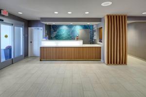 a lobby with a reception desk in a hospital at SpringHill Suites Port Saint Lucie in Port Saint Lucie