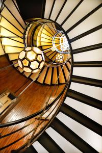 バルセロナにあるコットン ハウス ホテル オートグラフ コレクションのステンドグラス天井のらせん階段