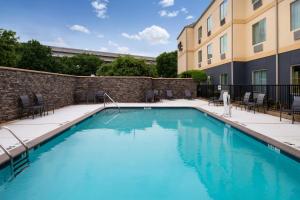 a swimming pool in front of a building at Fairfield Inn Arlington Near Six Flags in Arlington