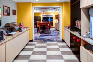 a kitchen with yellow walls and a checkered floor at TownePlace Suites by Marriott Bakersfield West in Bakersfield