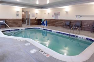 a large swimming pool with a person walking next to it at Fairfield Inn & Suites by Marriott Fort Morgan in Fort Morgan