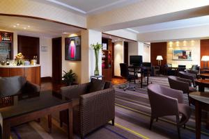 a hotel lobby with chairs and tables and a bar at Sheraton Brussels Airport Hotel in Zaventem