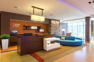 a lobby with a blue couch and a table at Fairfield Inn & Suites by Marriott Asheville Tunnel Road in Asheville