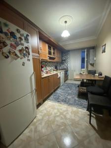 a kitchen with a white refrigerator and a table at İstanbul Otel Süit in Istanbul