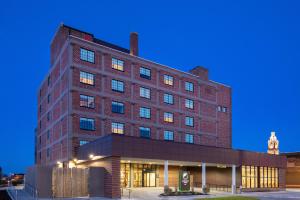 a large brick building at night at Element Moline in Moline