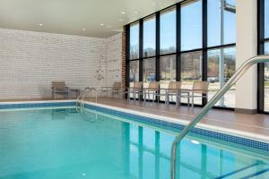 a swimming pool in a building with windows at Element Moline in Moline