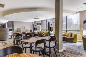 a lobby with tables and chairs and a couch at Courtyard Rockaway-Mount Arlington in Mount Arlington