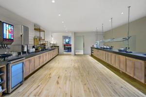 a large kitchen with wooden floors and a large counter at Residence Inn by Marriott Orlando at FLAMINGO CROSSINGS Town Center in Orlando