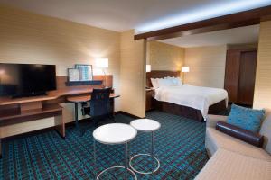 a hotel room with a bed and a desk with a computer at Fairfield Inn & Suites by Marriott Scottsbluff in Scottsbluff