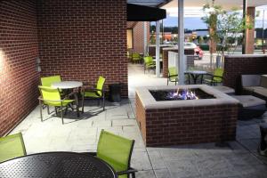 a patio with tables and chairs and a fire pit at Springhill Suites Baltimore White Marsh/Middle River in Middle River
